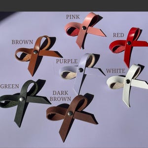 Color options for leather bows – brown, pink, purple, white, black, green, and red