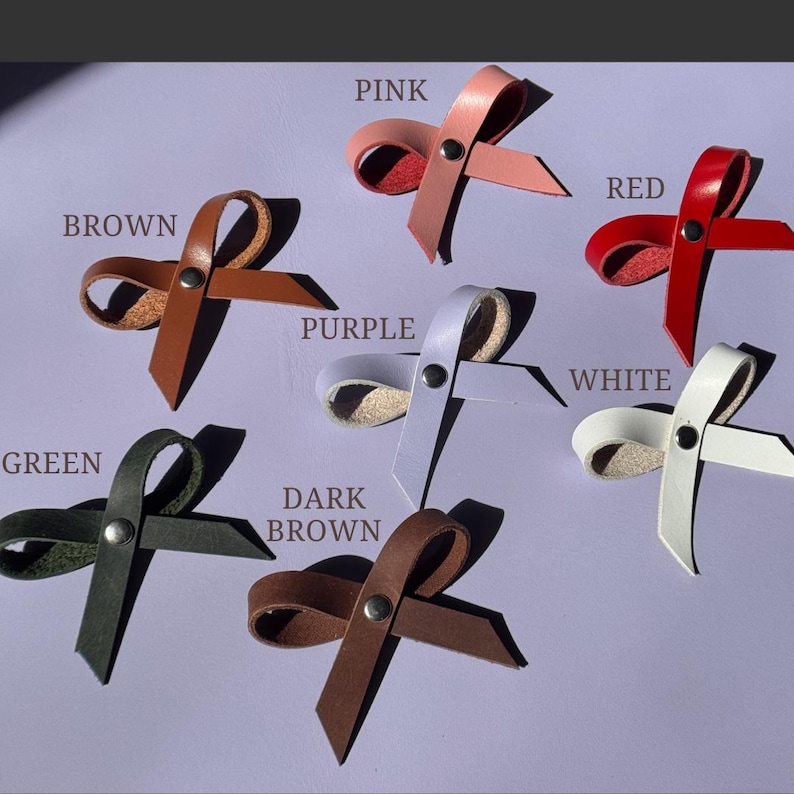 Color options for leather bows – brown, pink, purple, white, black, green, and red