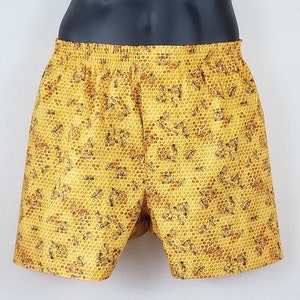 May include: Yellow boxer shorts with a honeycomb pattern and bees printed all over.