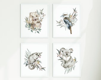 May include: Set of four framed watercolor prints featuring Australian animals. The prints depict a koala, a wombat, a sugar glider, and a kookaburra, each surrounded by eucalyptus leaves.