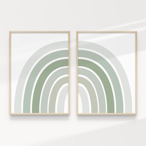 May include: Two framed prints of an abstract rainbow design in shades of green and white. The prints are in simple wooden frames and are hung on a white wall.