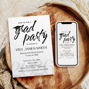 May include: A white graduation party invitation card and a smartphone displaying the same invitation design. The text reads: Join us for a grad party in honor of Kyle James Smith, Middleton High School, Class of 2026, Saturday, May 28th, 4pm to 8pm.