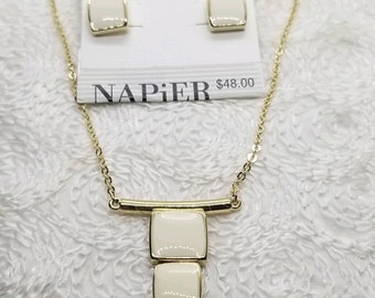 May include: Gold necklace with a bar and three white square pendants. Matching white square earrings are included. The necklace and earrings are from the brand Napier. The price tag reads $48.00.