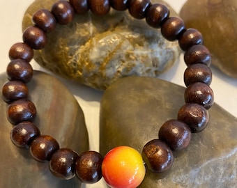 Natural Wood with a focal bead .. Beaded Bracelet