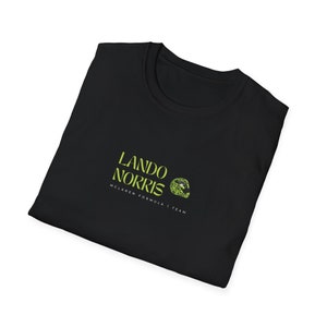 May include: Black t-shirt with a green logo that says "Lando Norris McLaren Formula 1 Team"