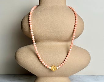 Coral beaded necklace with hand carved bone pendant