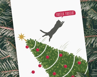 May include: A black cat leaps over a decorated Christmas tree, with ornaments falling to the ground. The cat has a speech bubble above it that says "Parkour Parkour!"