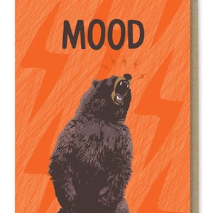 May include: A greeting card with an orange background and a black bear with its mouth open roaring. The text "MOOD" is printed in black at the top of the card.