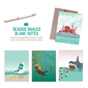 May include: A set of blank note cards with seaside-themed illustrations. The cards feature images of an octopus with ice cream, a seagull with chips, an otter with a snack, and a shark with donuts. The set includes a pen and a donut illustration. The text reads "Seaside Snacks Blank Notes".