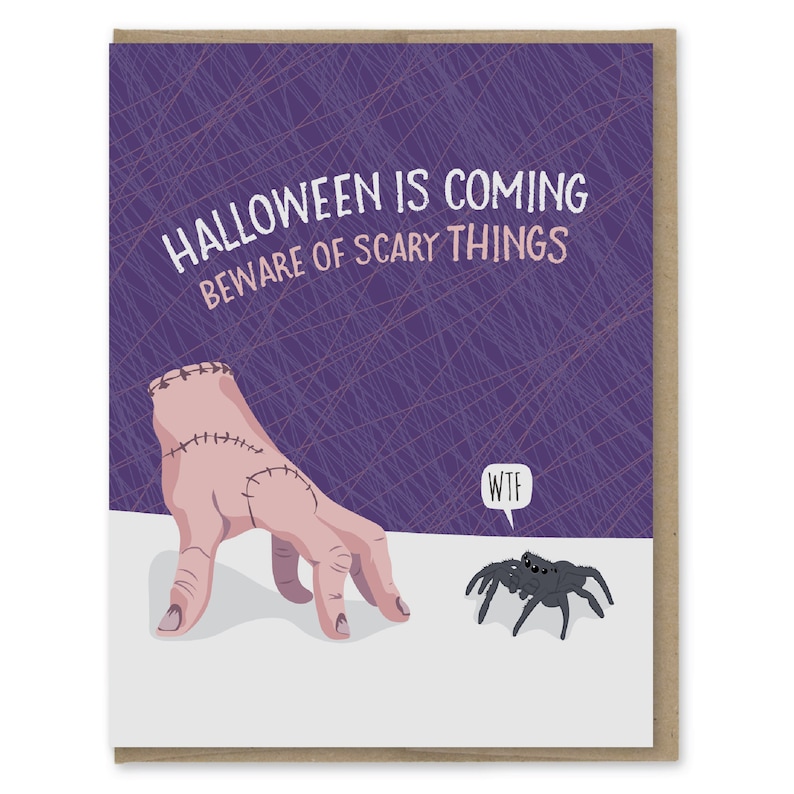 May include: A purple card with a stitched hand reaching out to a spider. The card says "Halloween is coming, beware of scary things" and "WTF" in a speech bubble above the spider.