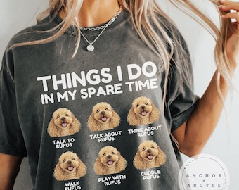 May include: Dark gray t-shirt with the text "THINGS I DO IN MY SPARE TIME" and images of a dog. The shirt lists activities like "TALK TO RUFUS" and "CUDDLE RUFUS". The brand name "ANCHOR + ARGYLE" is also visible.