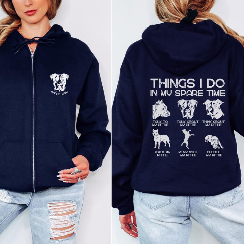 May include: A navy blue zippered hoodie with a white graphic on the front that says "Pittie Mom" and a white graphic on the back that says "Things I do in my spare time" with a list of activities involving a pit bull dog.