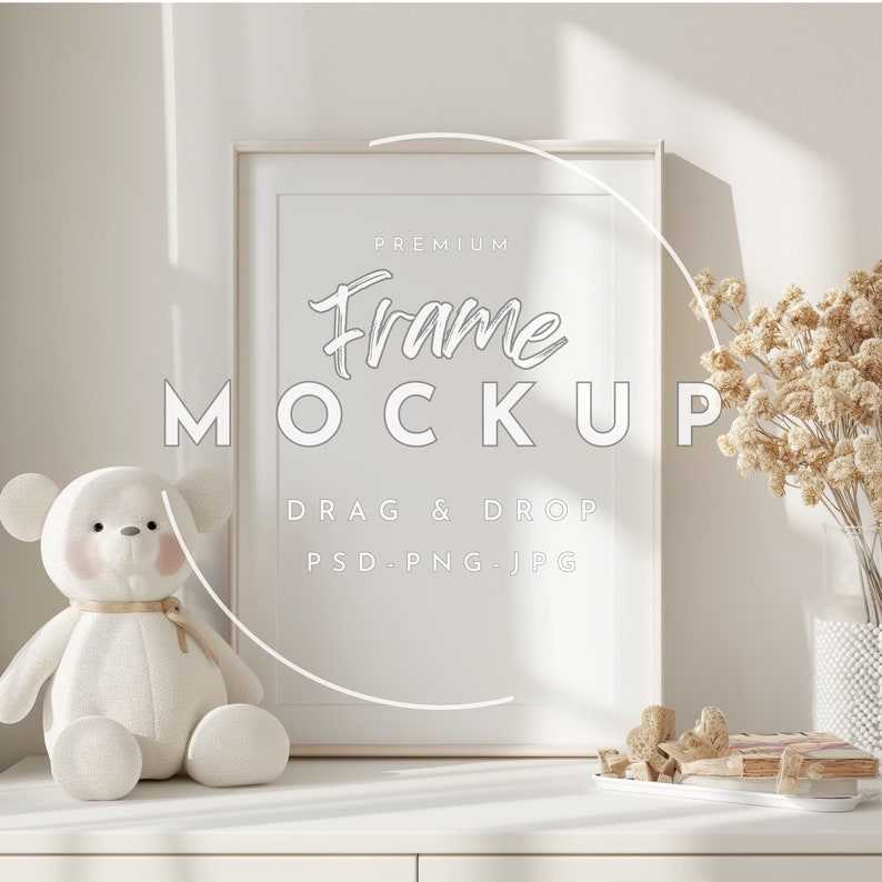May include: A white frame mockup with the text "PREMIUM Frame MOCKUP DRAG & DROP PSD.PNG.JPG" on a white surface with a white teddy bear and dried flowers in a vase.