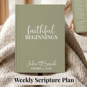 May include: A sage green hardback journal featuring white text that reads "faithful BEGINNINGS" and "John Sarah" with a heart symbol and the date "October 3, 2026". An inset shows the back cover with a printed scripture plan and instructions.