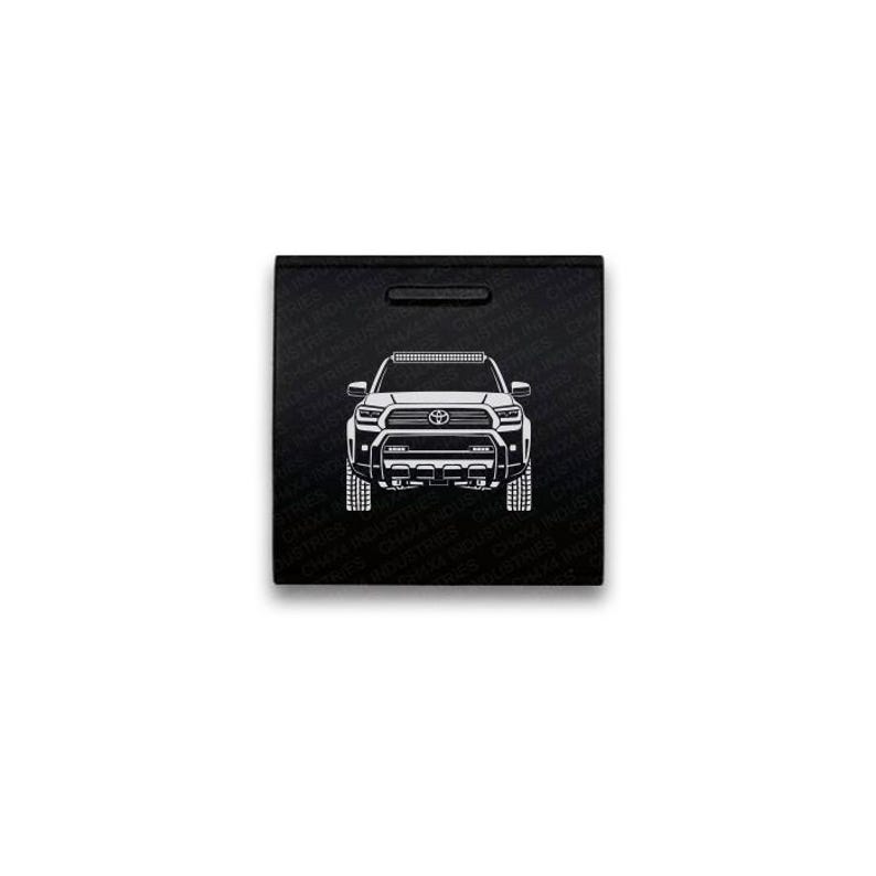 May include: A square black sign featuring a white line art illustration of a Toyota Tacoma truck from the front view. The background is patterned with the repeating text CHX4 INDUSTRIES. The truck design includes a grille, headlights, and a light bar.