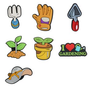 May include: A collection of colorful garden-themed charms. Includes a gardening fork, a gardening glove, a trowel, a sprouting plant, a potted plant, a charm with the text "I love gardening", and a sun hat with a yellow ribbon.