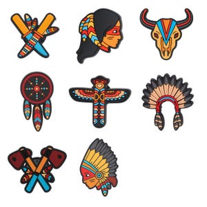 May include: A collection of colorful Native American-themed charms. The charms include a dreamcatcher, a headdress, a bull skull, crossed tomahawks, a profile of a person with a headdress, a totem pole, and crossed knives.