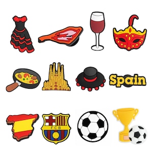 May include: A collection of colorful shoe charms featuring Spanish cultural icons. Includes a flamenco dress, a slice of jamón, a glass of red wine, a carnival mask, paella, the Sagrada Familia, a hat, the word "Spain", a map of Spain, a soccer team logo, a soccer ball, and a trophy.