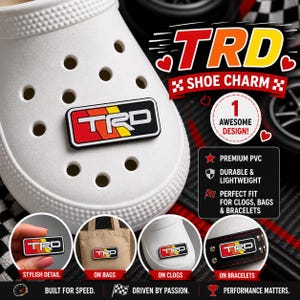 May include: White clog shoe with a black, red, and yellow TRD shoe charm. The image shows the charm on a shoe, bag, clog, and bracelet. Text on the image says "Shoe Charm", "Awesome Design", "Premium PVC", and "Durable & Lightweight".