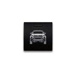 May include: A square black box featuring a white line art illustration of a Toyota truck front view centered on the lid. The background of the box is embossed with a repeating pattern of the text CHX4 INDUSTRIES in a subtle dark finish.