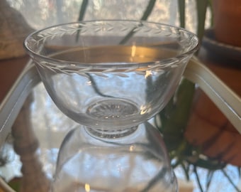 One etched glass thin flared laurel leaf bowl with starburst design in base