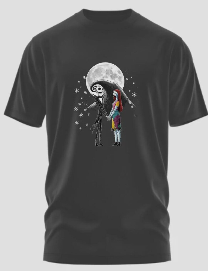 May include: Dark gray t-shirt featuring a graphic of Jack Skellington and Sally from The Nightmare Before Christmas, holding hands in front of a full moon. The design includes stars and is a fan art depiction of the characters.