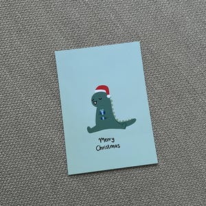 Dino Merry Christmas Weihnachts Postkarte, Dinosaurier, witzig Grußkarte, süße Geschenkidee, Geschenk für ihn, Weihnachten, Nikolaus
