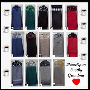 May include: A collection of hanging kitchen towels in various colors and patterns, including blue, green, black, red, and gray. Each towel has a decorative top with different fabric designs. The image also includes coffee cups.