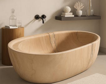 May include: A light-colored wooden bathtub with an oval shape. The tub has a natural wood grain pattern and is set in a modern bathroom. A small wooden side table, a faucet, and decorative items are also visible.