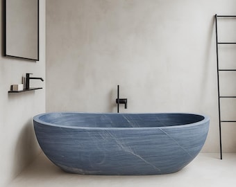 May include: A contemporary, oval bathtub in a muted blue colour is the focal point. The tub has a textured surface with subtle veining. A black tap and a minimalist black ladder are visible. The bathroom has a neutral colour palette.