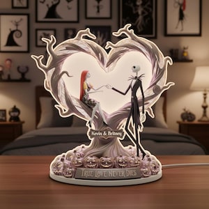May include: A decorative lamp featuring Jack Skellington and Sally from The Nightmare Before Christmas. The lamp has a heart-shaped frame with the couple holding hands. The base has pumpkins and the text "TRUE LOVE NEVER DIES". The names "Kevin & Britney" are also displayed.