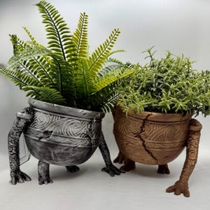 May include: A white ceramic mug with a black handle and the text "But First, Coffee" in a bold, black font. The mug is set against a blurred background, suggesting a cosy setting.