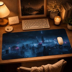 May include: A rectangular mouse mat depicting a futuristic city with tall buildings, flying vehicles, and a glowing orb. The mat is dark blue with neon pink and blue accents. A white mouse and keyboard are also visible.