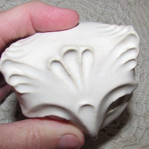 May include: White ceramic owl figurine with detailed textured feathers and a round shape.