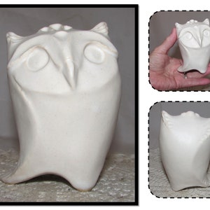May include: White ceramic owl sculpture with a rounded body and large eyes. The owl is standing on a flat surface.