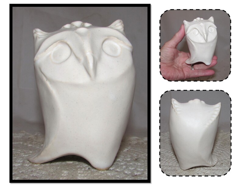 May include: White ceramic owl sculpture with a rounded body and large eyes. The owl is standing on a flat surface.
