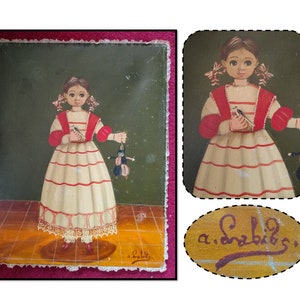 May include: A painting of a young girl in a white dress with red stripes and red sleeves. She is holding a small doll in her right hand. The painting has a green background and is signed "a.Sabbls" in the bottom right corner.