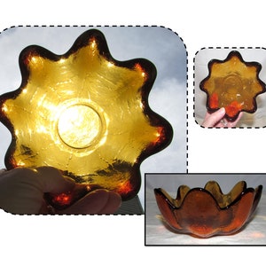 May include: A set of three amber glass bowls with a wavy, organic shape. The bowls are made of thick glass and have a slightly iridescent finish.
