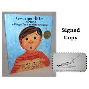 May include: A signed copy of the children's book "Lucas and His Loco Beans: A Bilingual Tale of the Mexican Jumping Bean." The book cover features a cartoon illustration of a boy holding two jumping beans. The book is a BrainStorm 3000 publication.