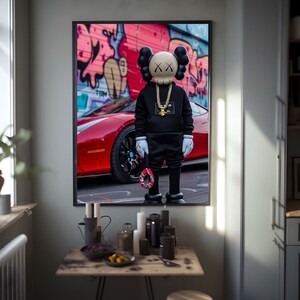 May include: A black and white illustration of a cartoon character wearing a black hoodie and a gold chain, standing in front of a red sports car with graffiti in the background.