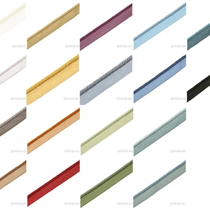 May include: A collection of nineteen diagonal strips of piping trim in various solid colors including white, gold, purple, light blue, teal, grey, navy, black, brown, orange, light green, red, and olive, each featuring a corded edge.