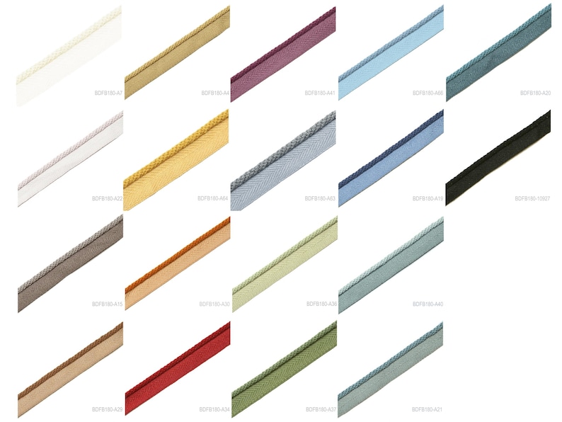 May include: A collection of nineteen diagonal strips of piping trim in various solid colors including white, gold, purple, light blue, teal, grey, navy, black, brown, orange, light green, red, and olive, each featuring a corded edge.
