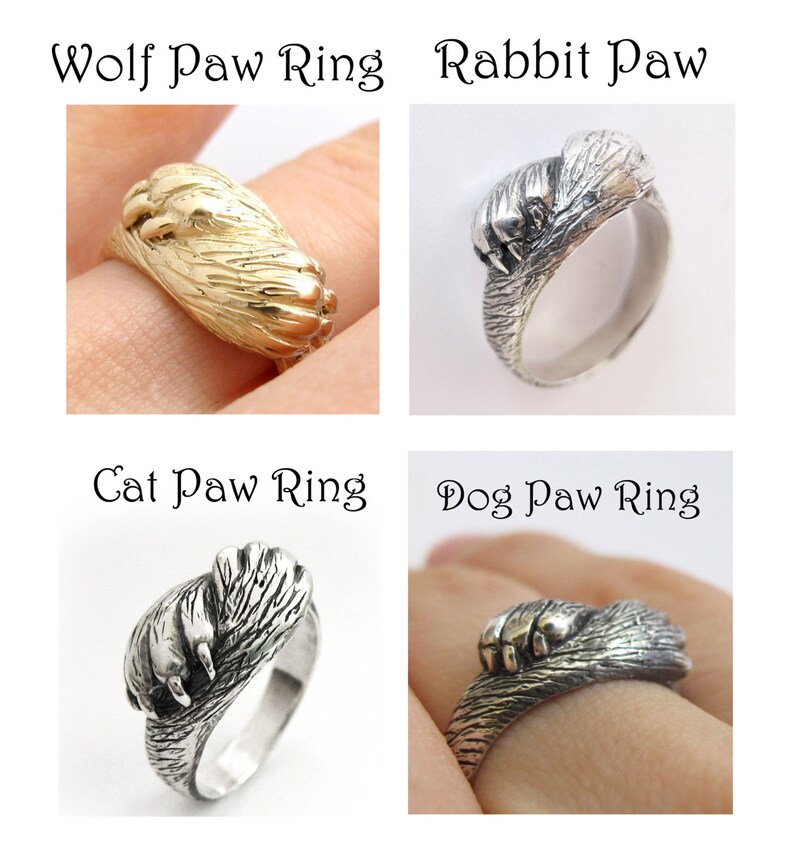 May include: Four silver rings with animal paw designs. The rings are labeled "Wolf Paw Ring", "Rabbit Paw", "Cat Paw Ring", and "Dog Paw Ring".