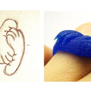 May include: A blue wax ring with a textured design resembling a bird's wing.