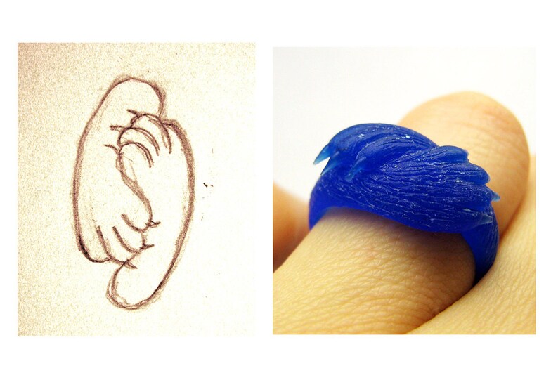 May include: A blue wax ring with a textured design resembling a bird's wing.
