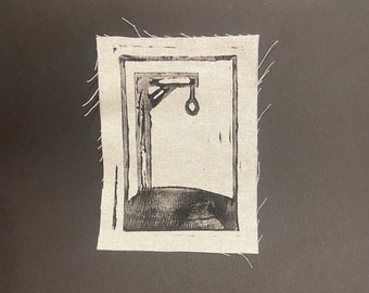 Pode incluir: Uma impressão em preto e branco de uma forca com uma corda pendurada nela. A impressão é emoldurada em um tecido branco com uma borda desfiada.
