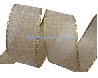 May include: A roll of tan ribbon with a woven texture and gold trim. The ribbon is curled, showing the front and side edges. The gold trim is a thin, metallic thread that runs along the edges of the ribbon. The ribbon is on a white background.