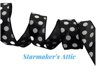 May include: Black and white polka dot ribbon with white dots on a black background. The ribbon is curled and twisted.