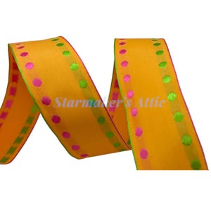 May include: Yellow ribbon with pink and green polka dots. The ribbon is a satin material with a subtle sheen.