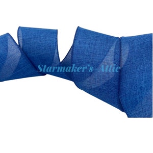 May include: A roll of blue wired ribbon with a textured, linen-like finish. The ribbon is approximately 2.5 inches wide.